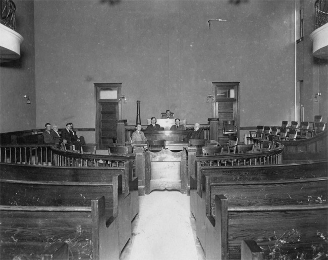 Williamson County Courthouse District Courtroom: Charles McMurray (county clerk) seated to the right; Judge Critz seated at center. Image ca. 1912. photo credit Williamson County Museum